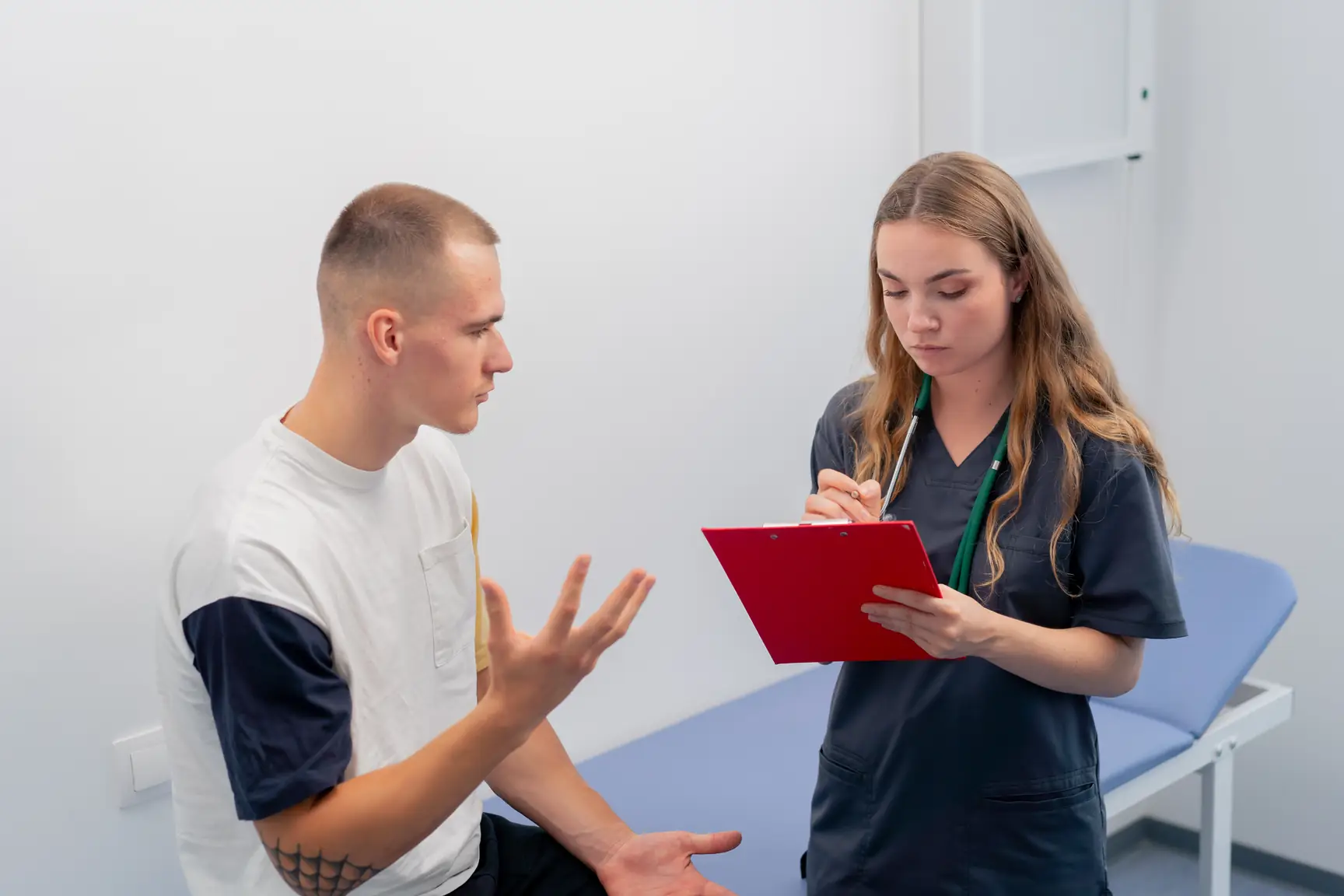 Physiotherapist talking through a treatment plan with a patient in a clinic