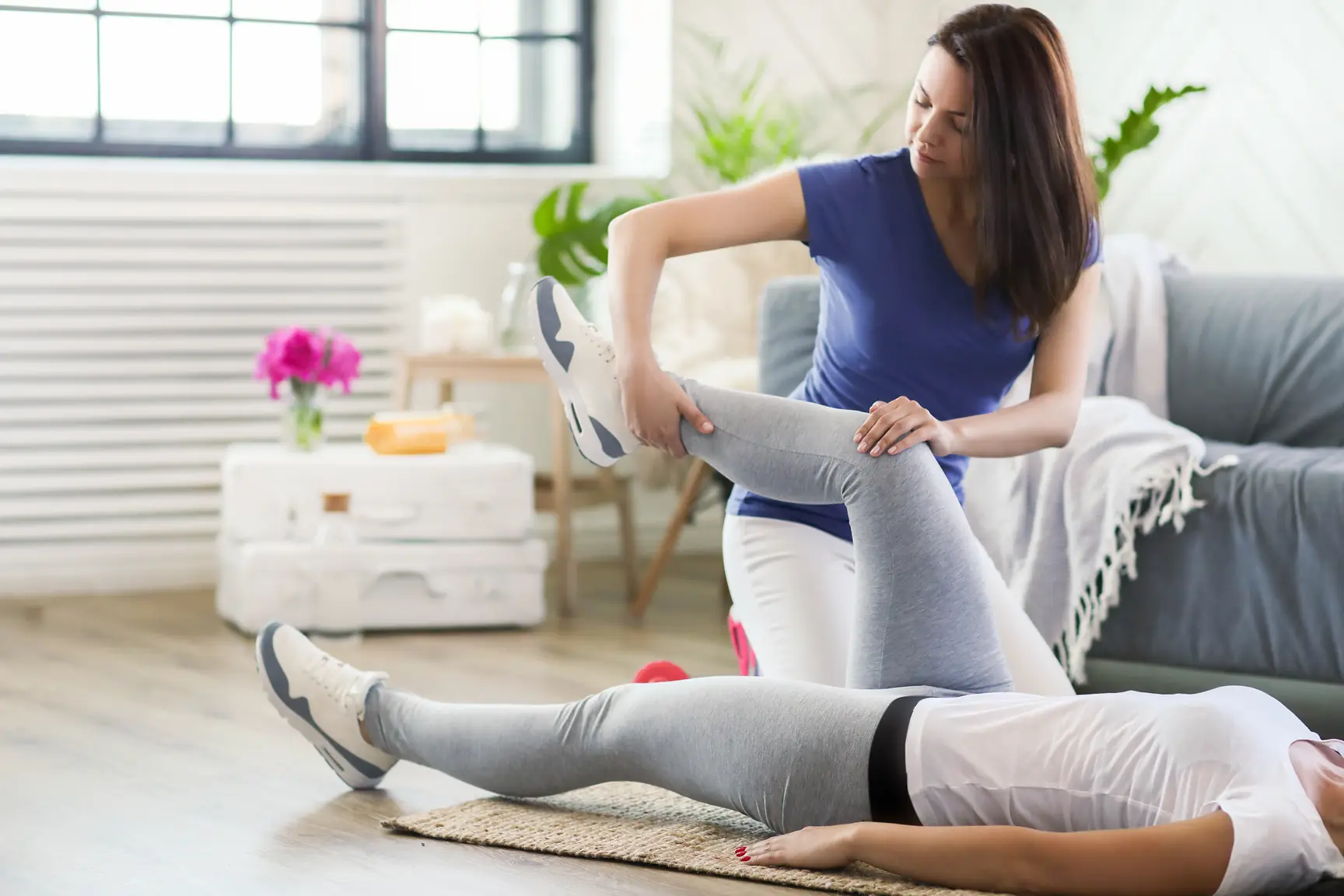 Physiotherapist treating the back of an athlete's thigh